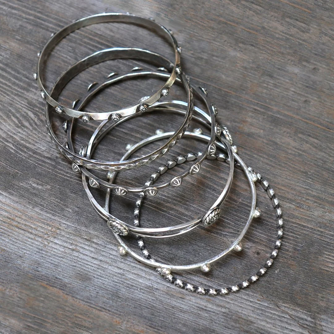 multiple one-of-a-kind handmade silver bangles