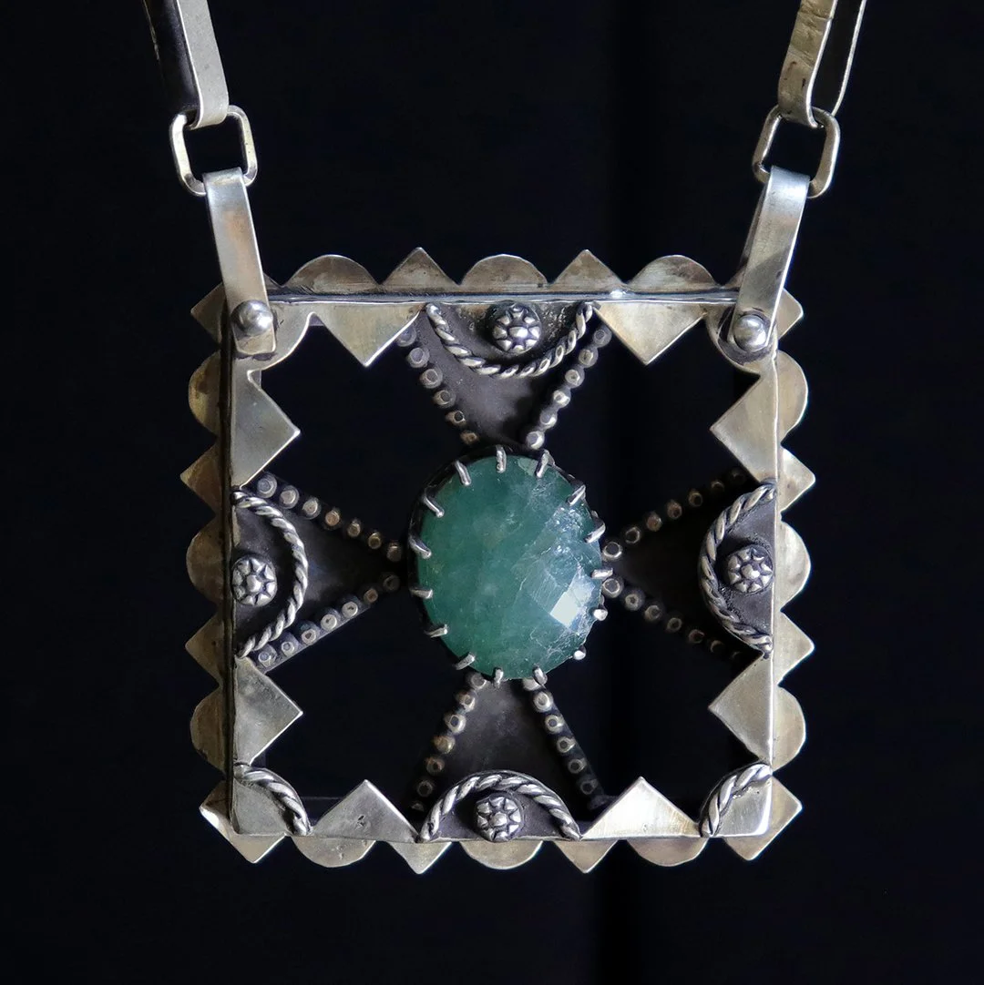 Square silver pendant featuring grandidierite in an open geometric frame