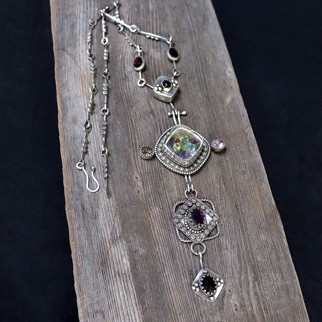 Artisan silver statement necklace featuring layered geometric forms