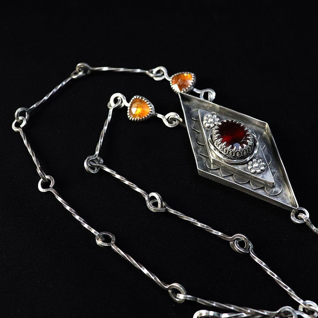 Artisan silver necklace with hessonite garnet and red garnet