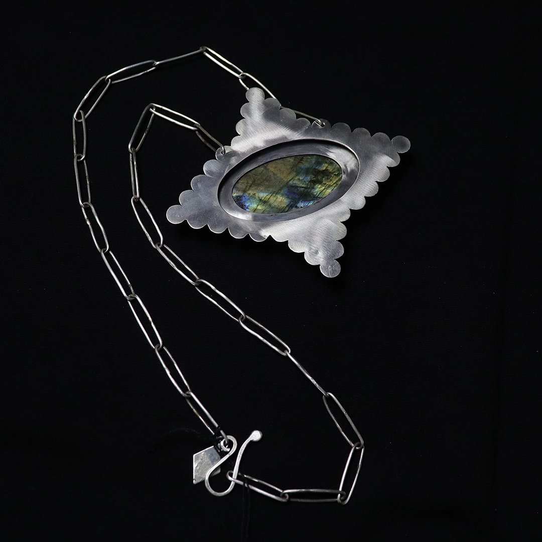decorative silver pendant with labradorite cabachon