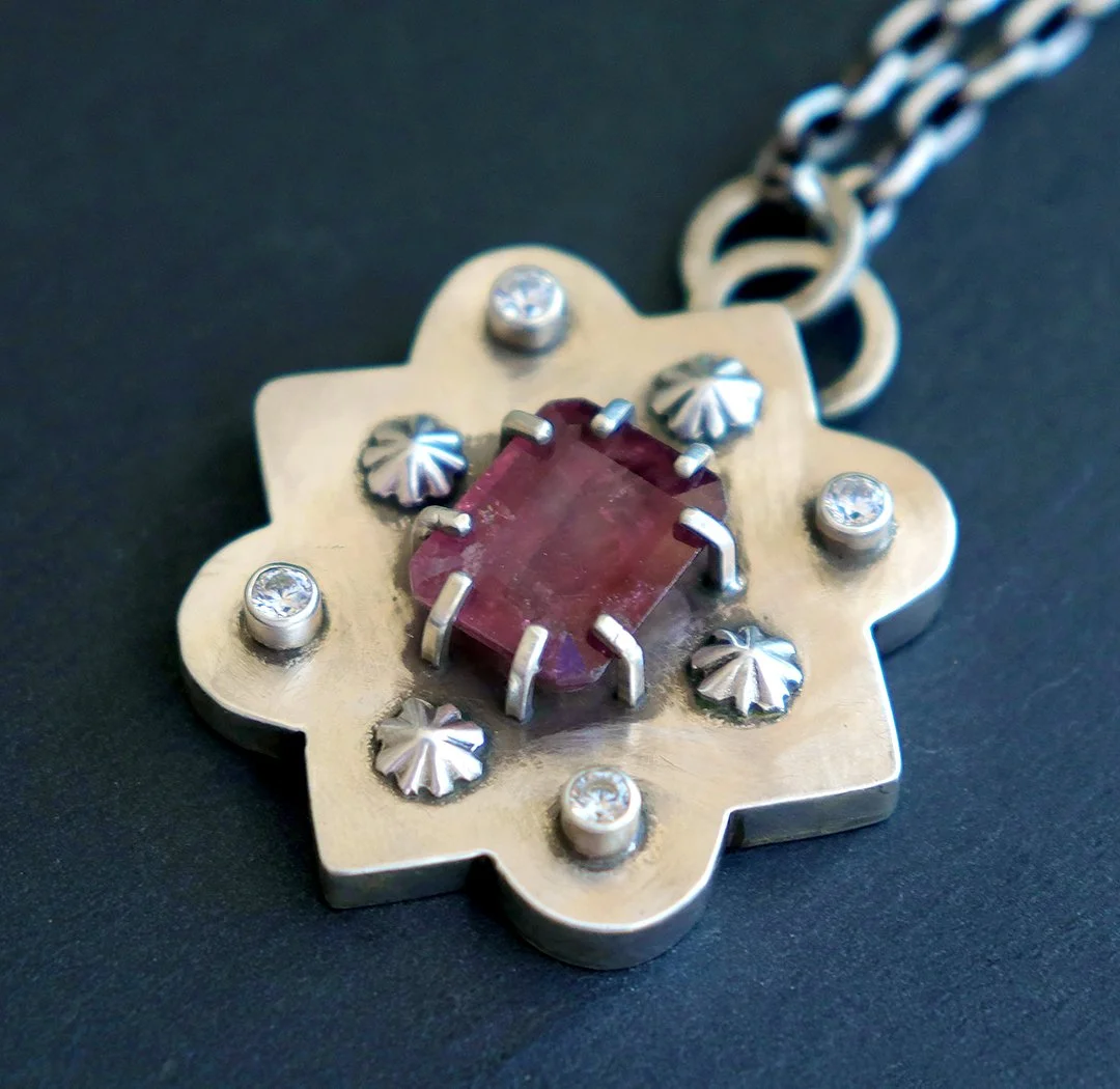 Sterling silver pendant featuring a deep red rubellite tourmaline in a sculptural moroccan style setting