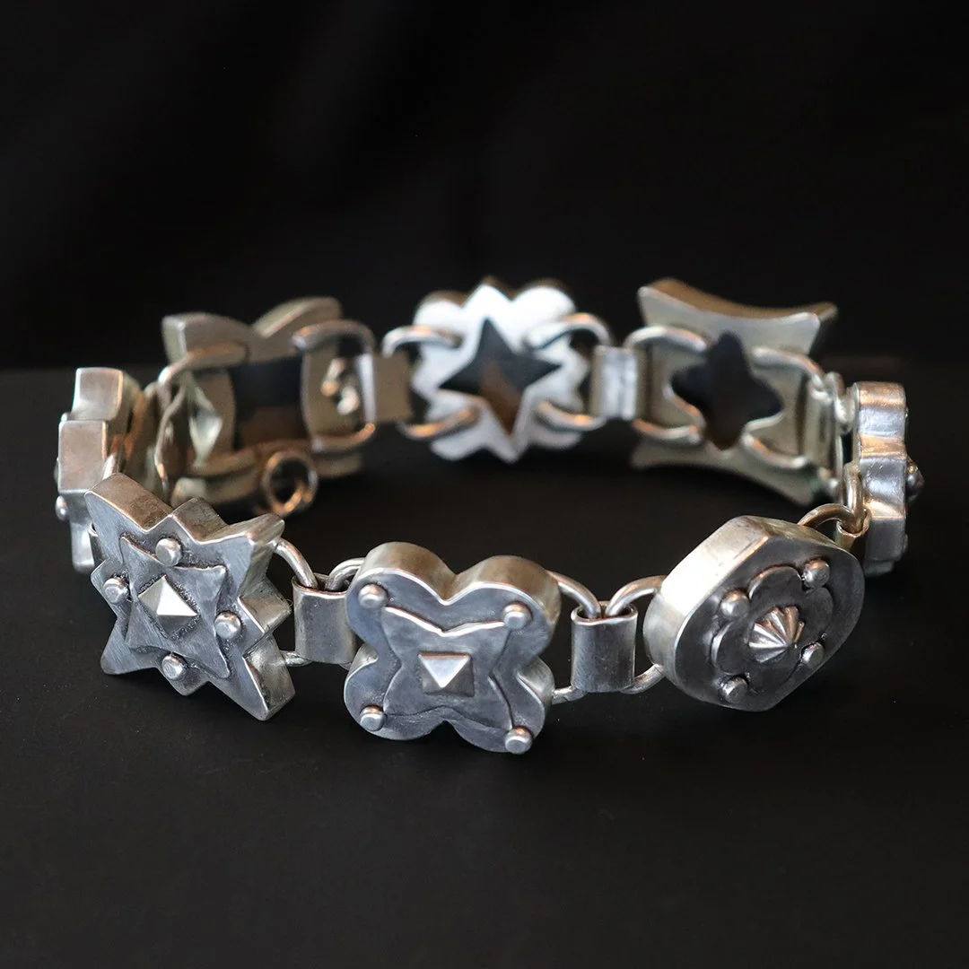 Hand-fabricated silver medallion bracelet with architectural form