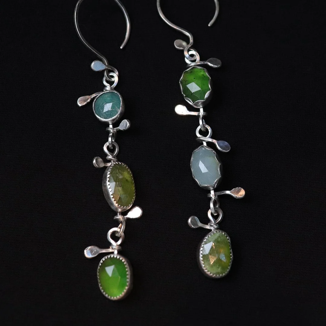 Handmade silver earrings featuring mixed green gemstones in linked design