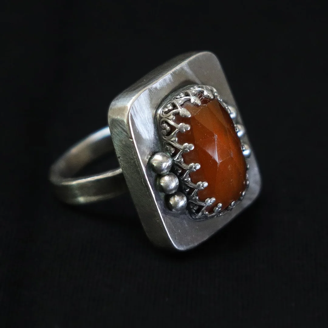 One-of-a-kind silver ring with hessonite garnet in a sculptural setting