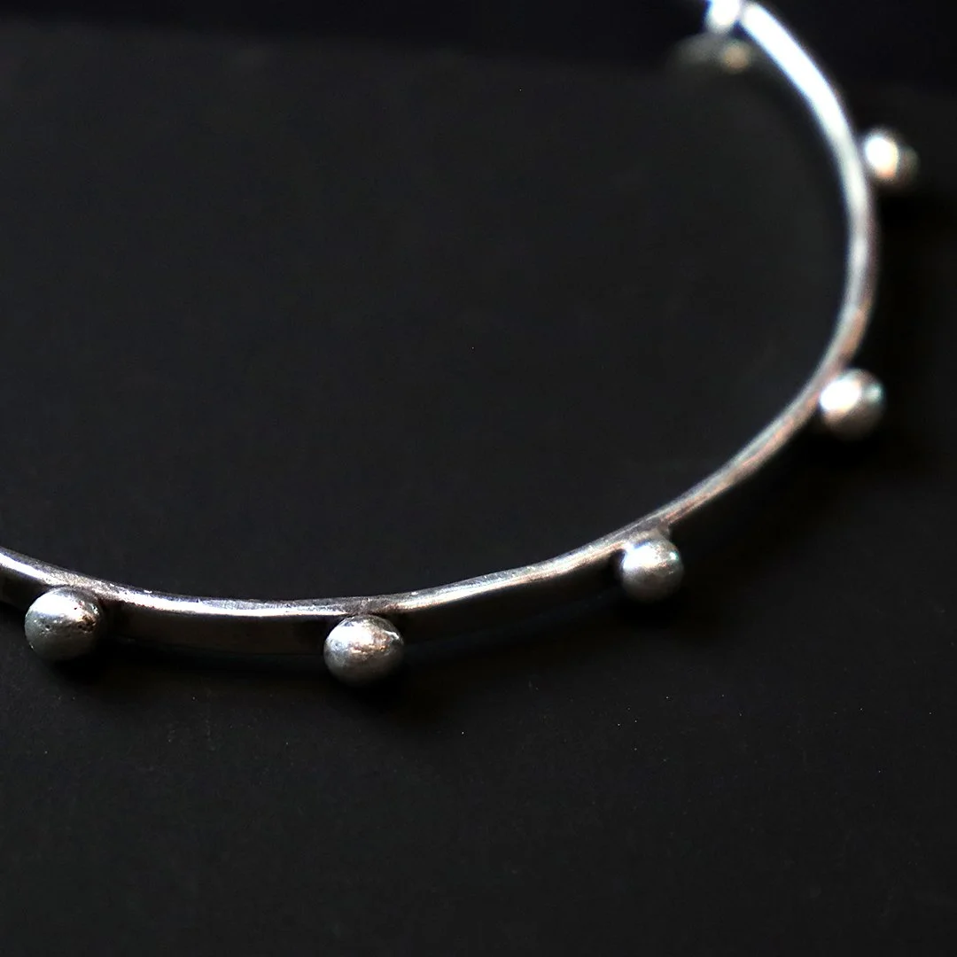 Minimalist sterling silver bangle with granule accents