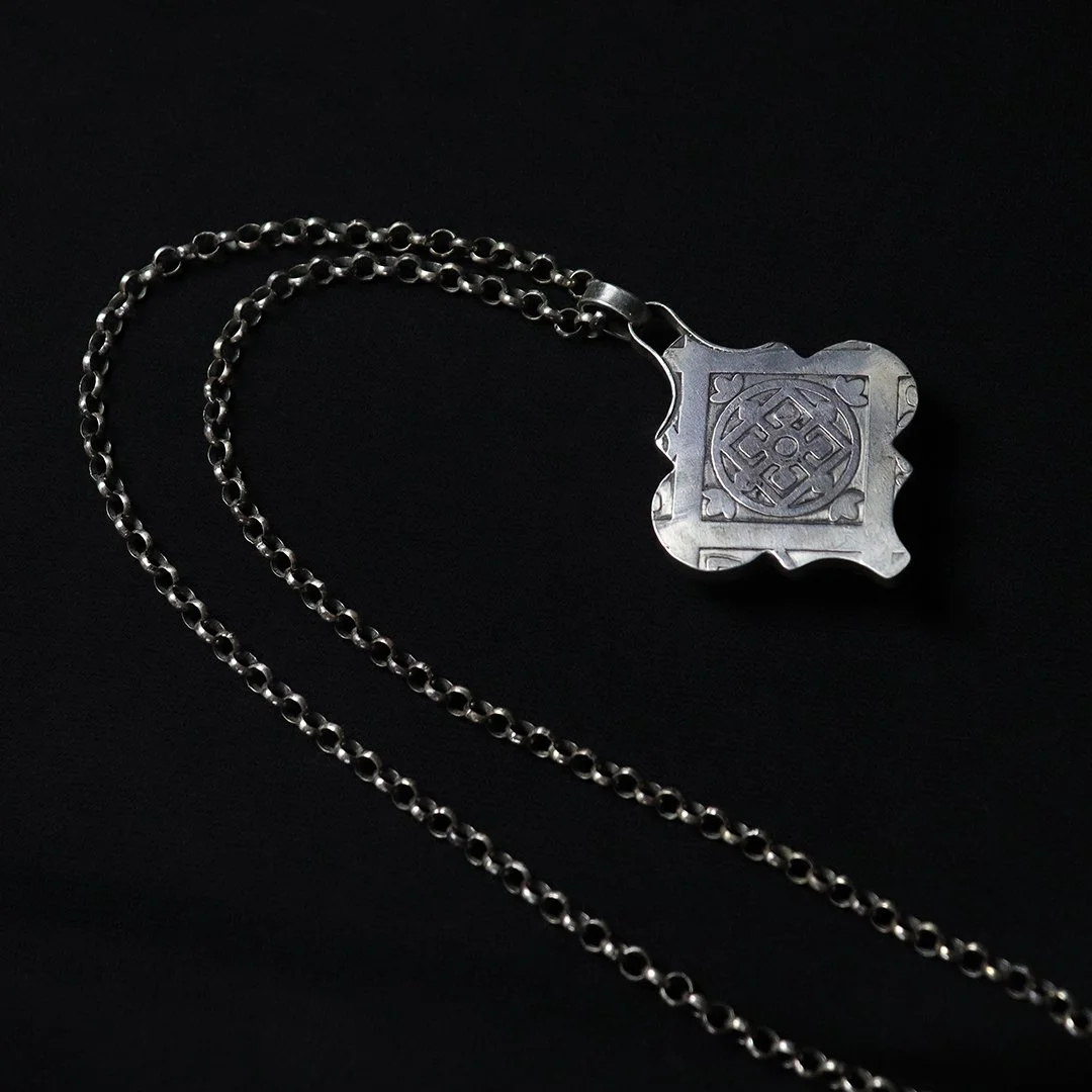 Artisan silver pendant featuring oval vesuvianite gemstone