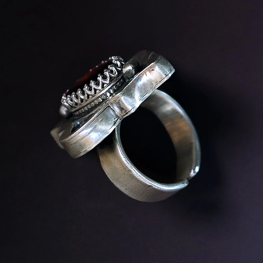 Hand-fabricated silver ring showcasing a red garnet gemstone
