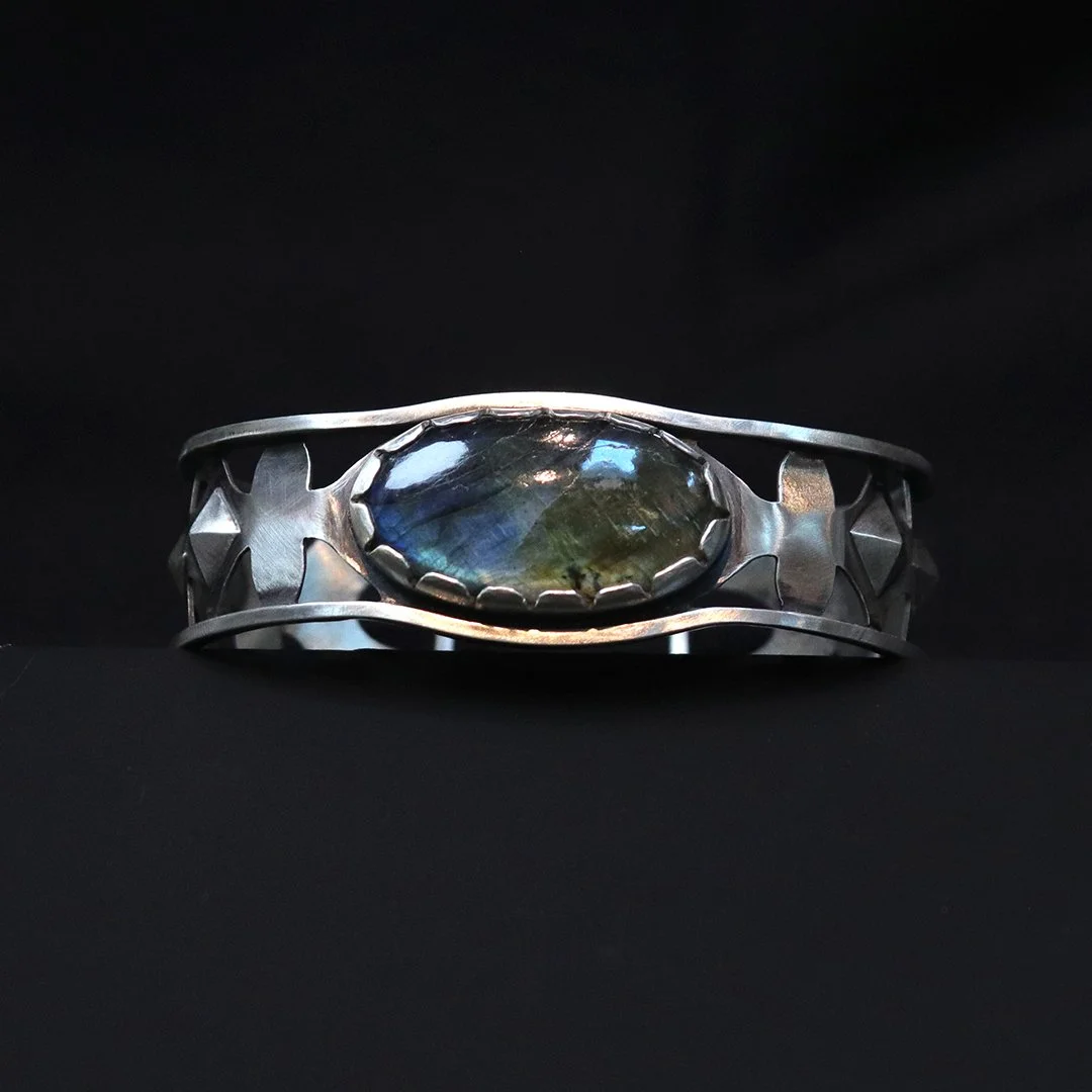 Openwork sterling silver cuff featuring oval labradorite with blue-green flash