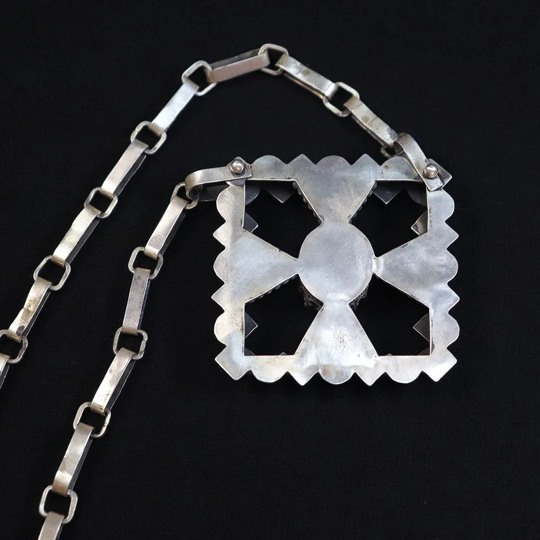 Artisan silver pendant with grandidierite and architectural openwork design