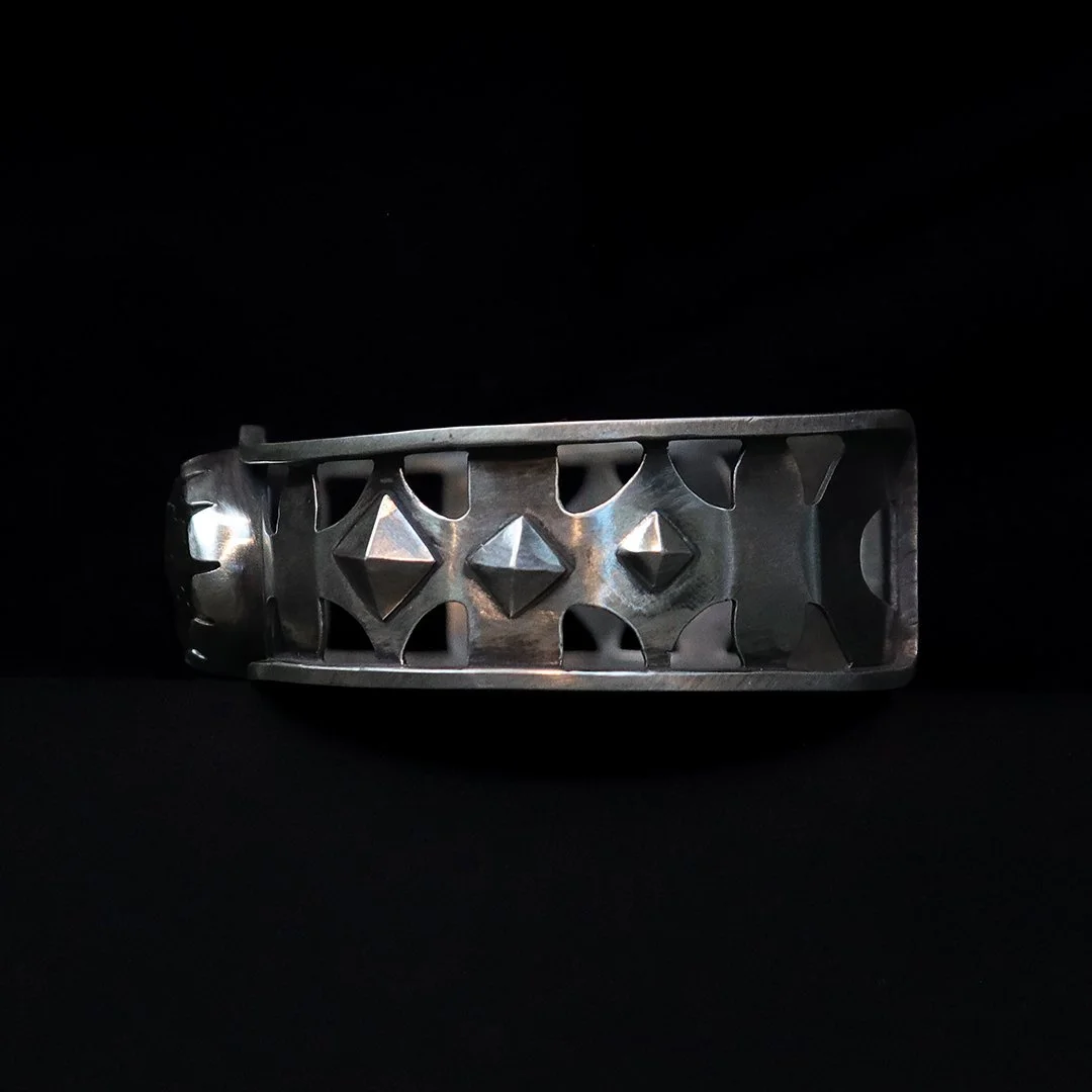 Artisan silver cuff bracelet with pierced details and luminous labradorite stone