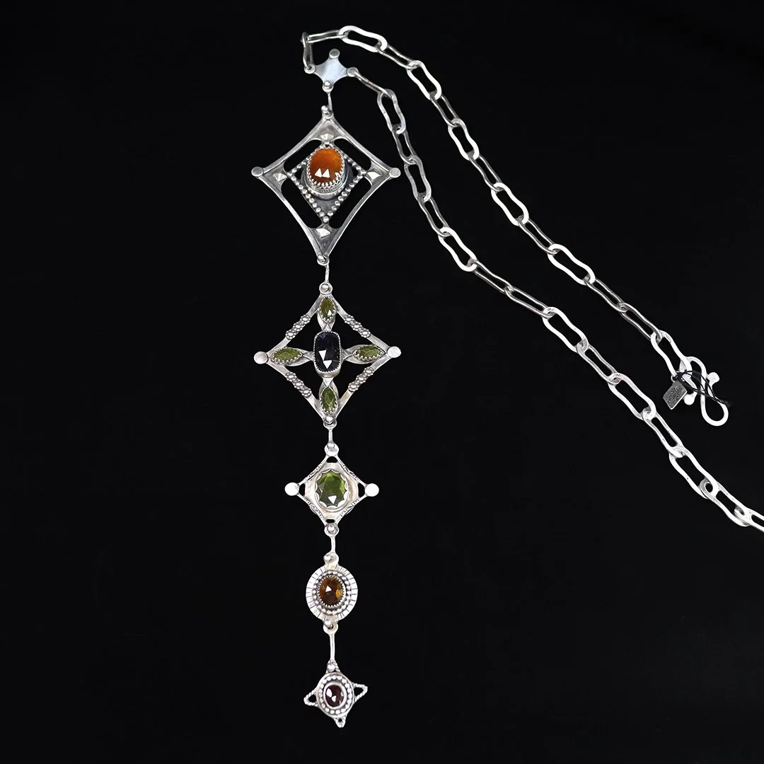 Statement necklace with carnelian vesuvianite iolite and garnet in silver