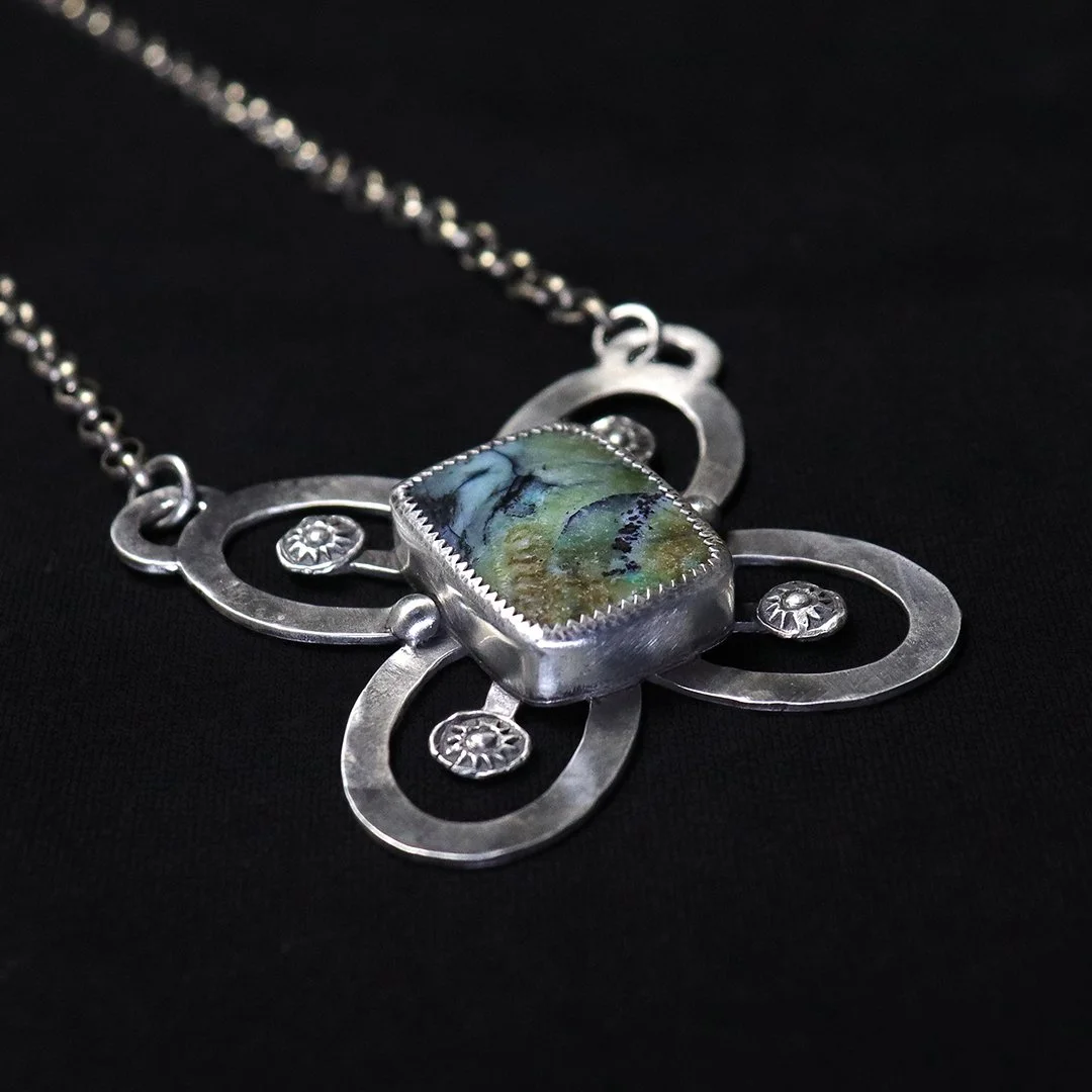 Floral-inspired opalized wood gemstone pendant in sterling silver
