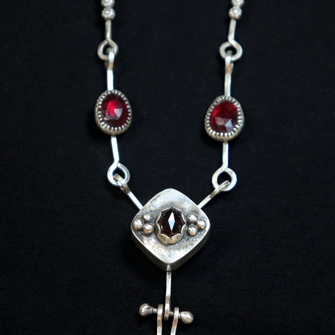 Vertical silver necklace with sculptural handmade components