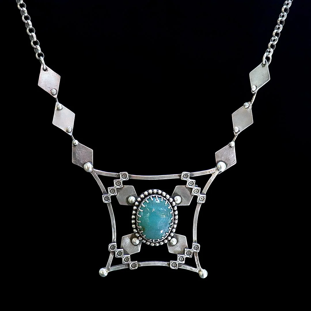 One-of-a-kind silver pendant with grandidierite in an architectural setting