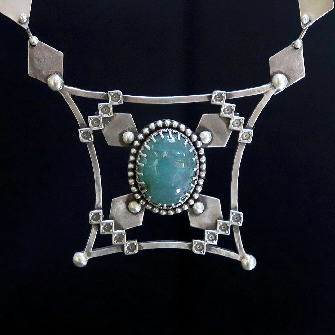 Handmade sterling silver pendant featuring a rare grandidierite gemstone