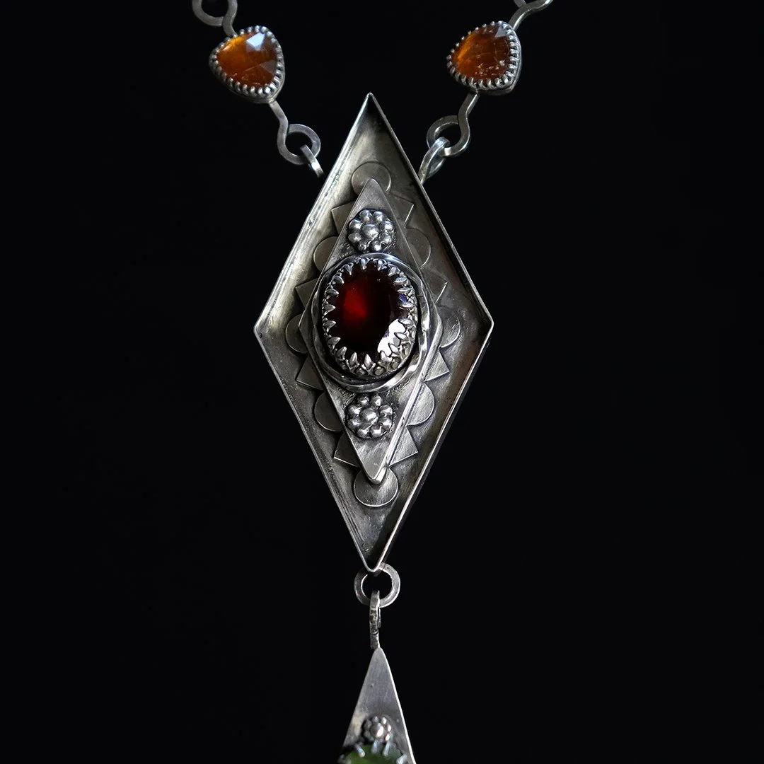 Geometric statement necklace with layered gemstones in silver