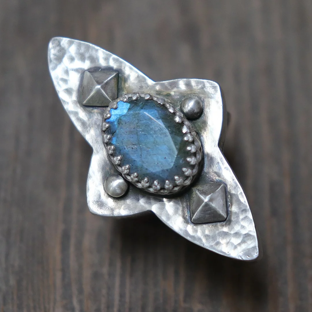 Artisan silver ring featuring blue flash labradorite in sculptural setting