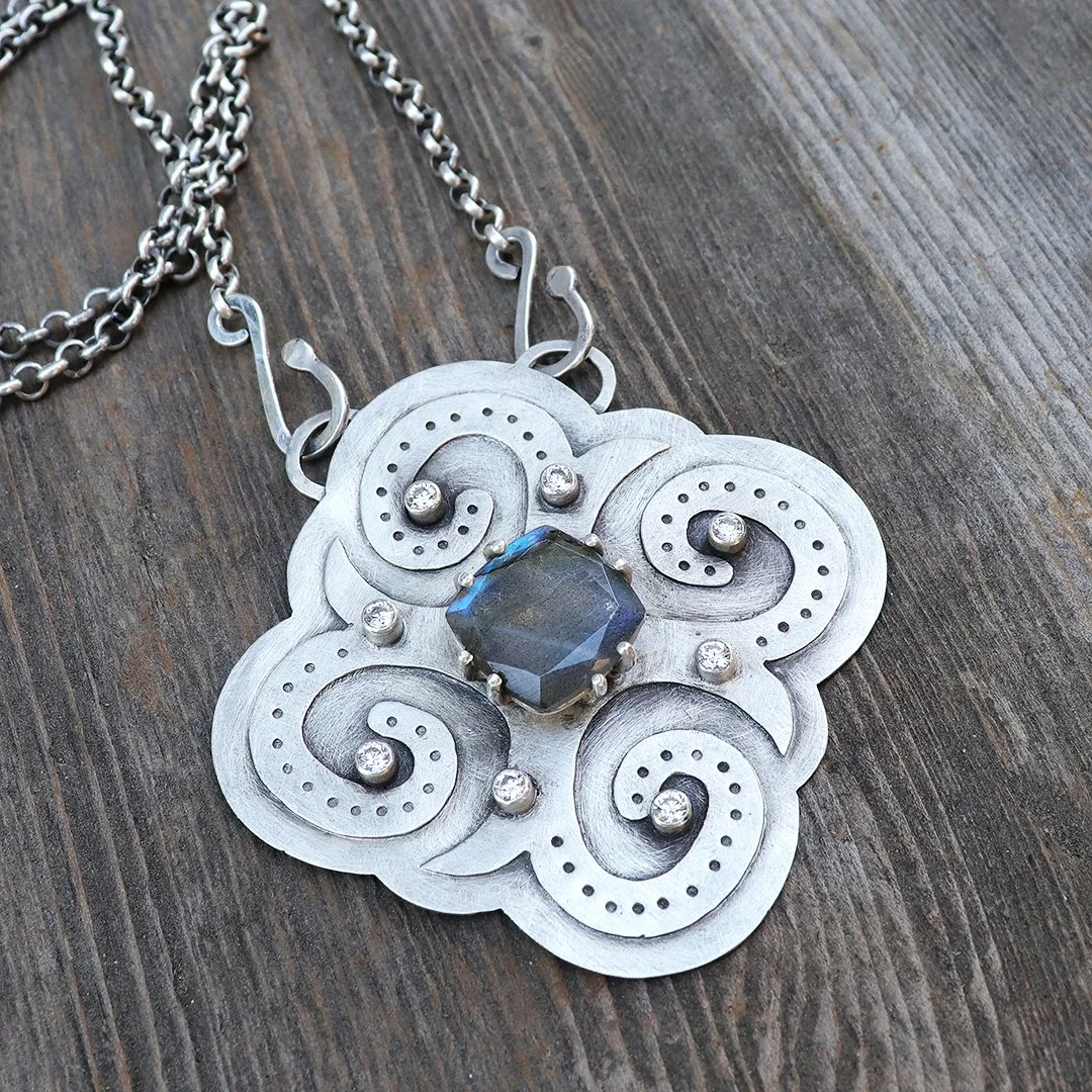 Sterling silver pendant with glowing labradorite and swirling cloud motifs