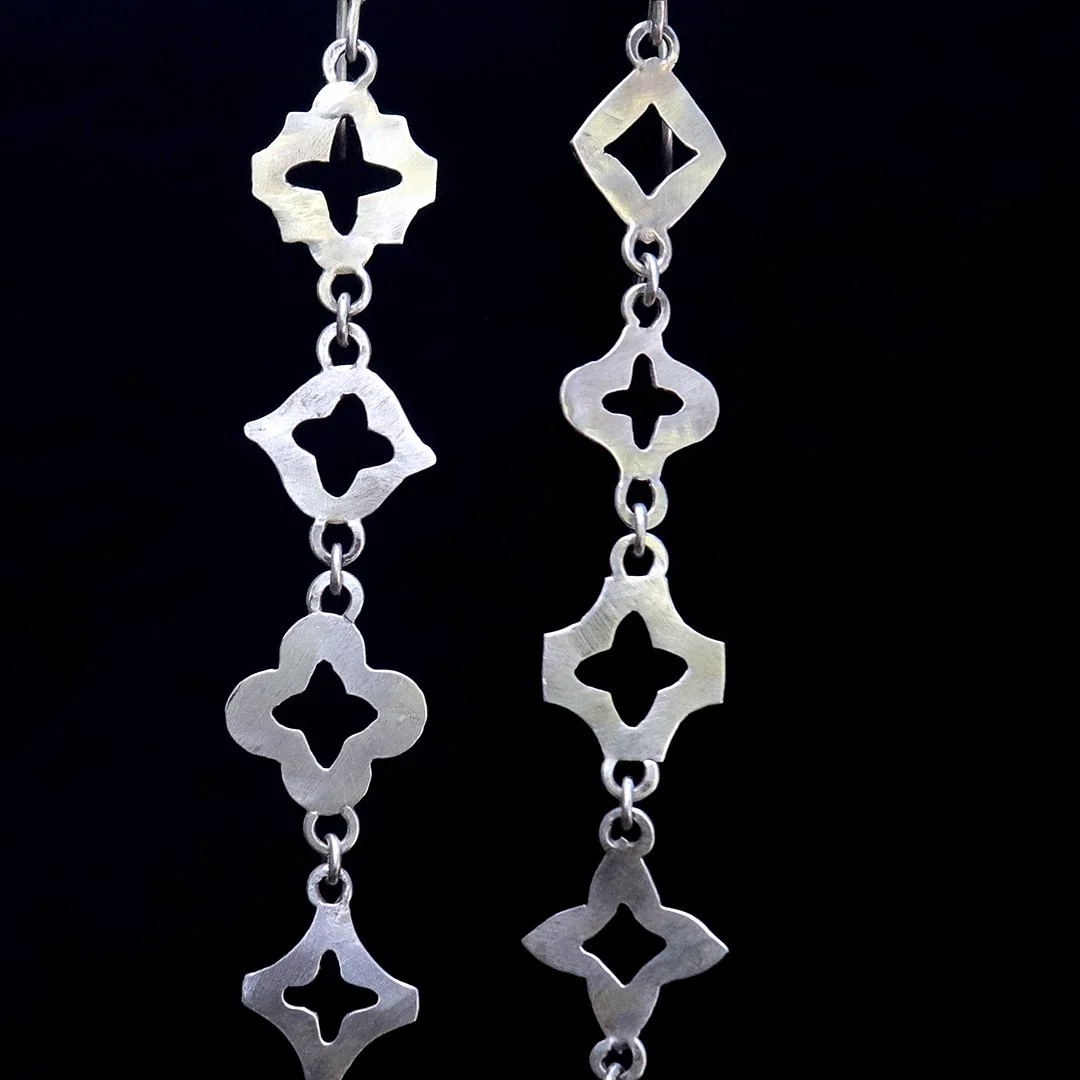 Handmade geometric silver earrings with linked forms