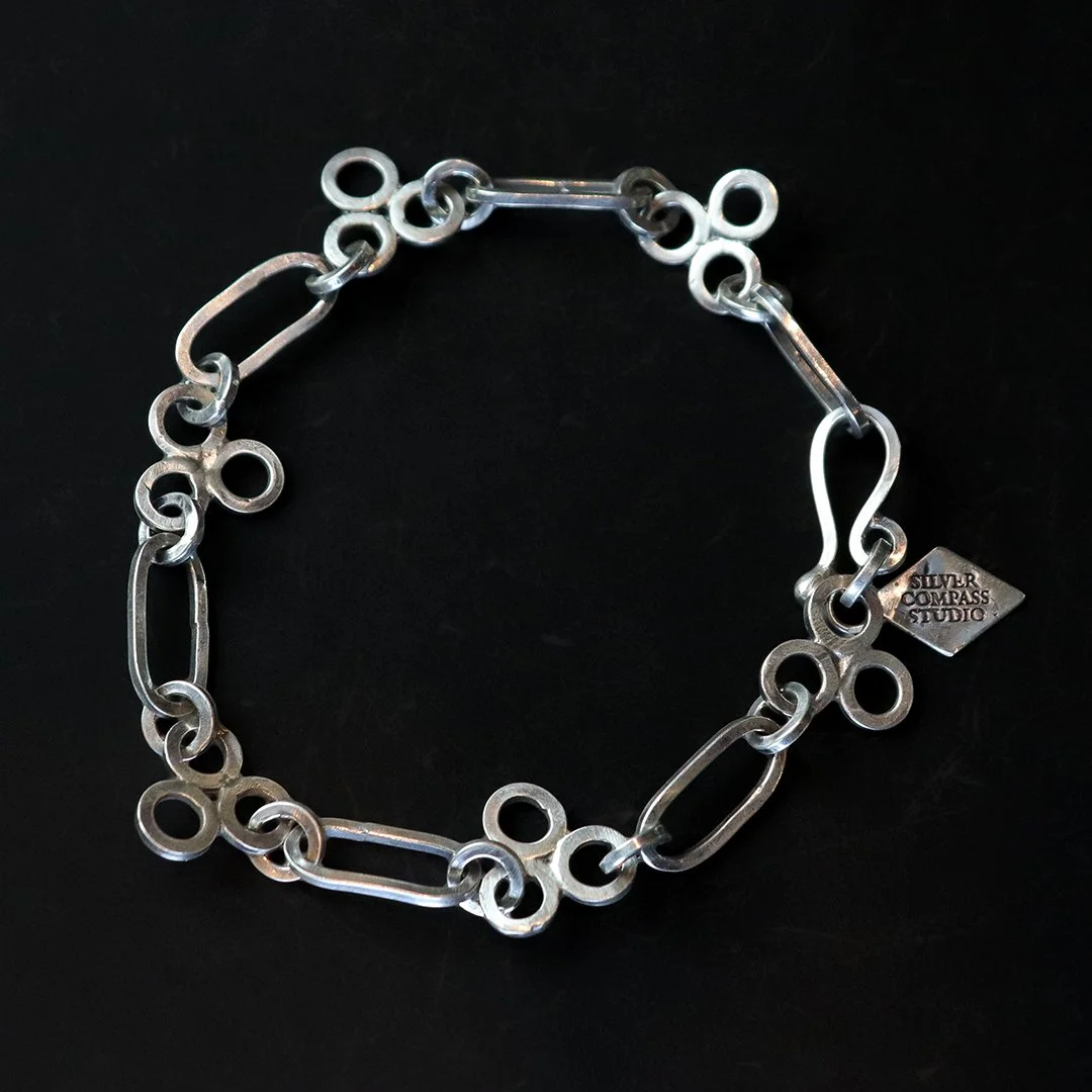Handmade sterling silver chain bracelet with alternating oval and circular links and hook clasp