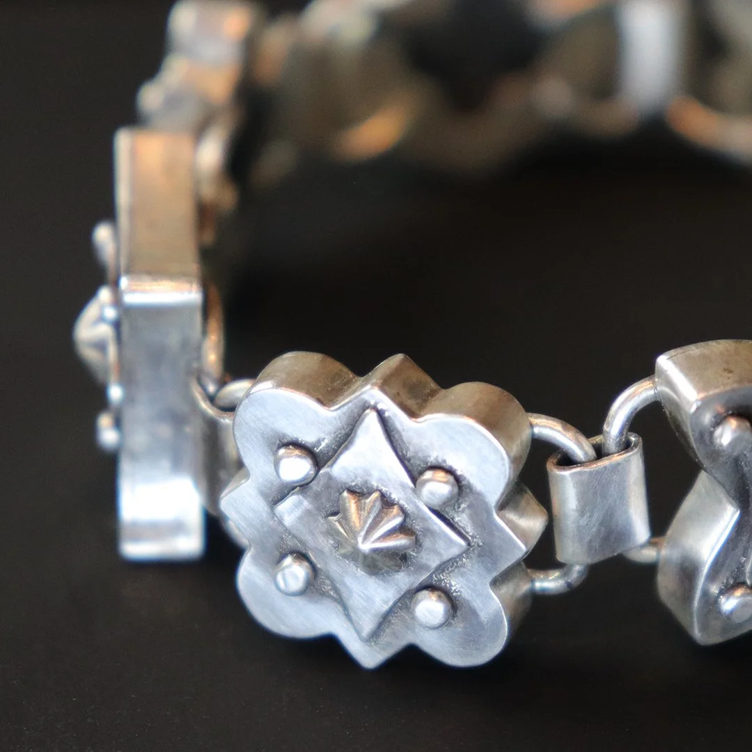 Handmade sterling silver bracelet with hollow form medallion detail