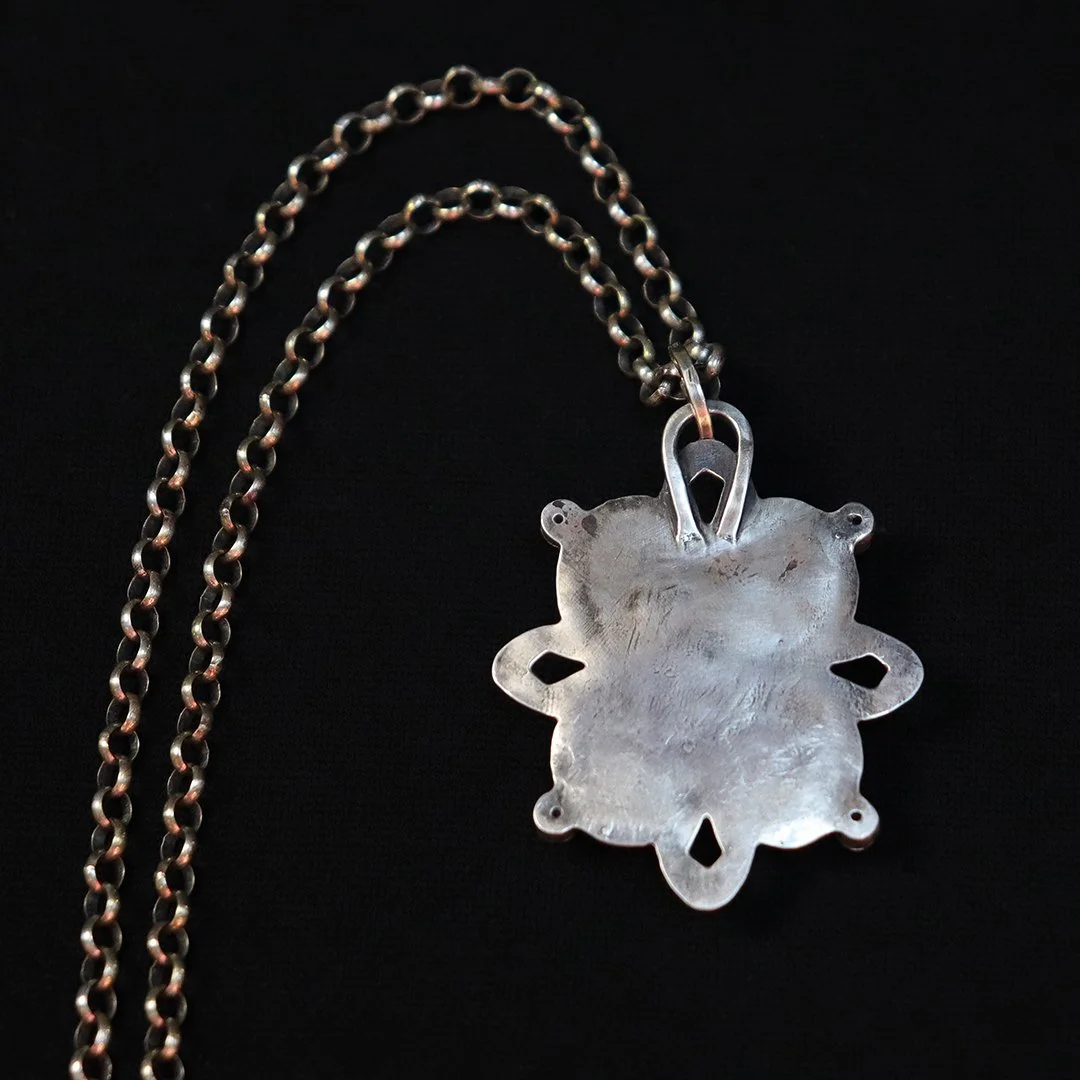 Handmade silver flower pendant featuring warm golden citrine center stone