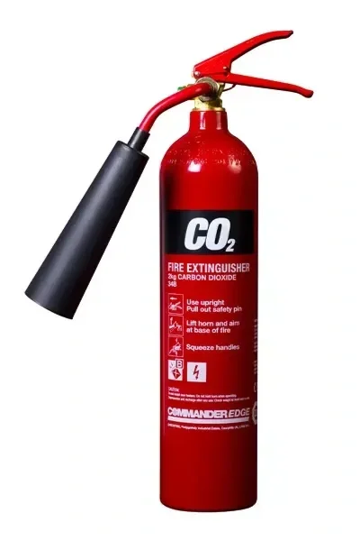 Red fire extinguisher with black nozzle and hose, labeled CO2, indicating it is a carbon dioxide fire extinguisher.