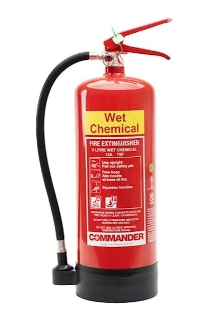Red wet chemical fire extinguisher with a black hose and red handle, labeled "Wet Chemical" and "Fire Extinguisher".