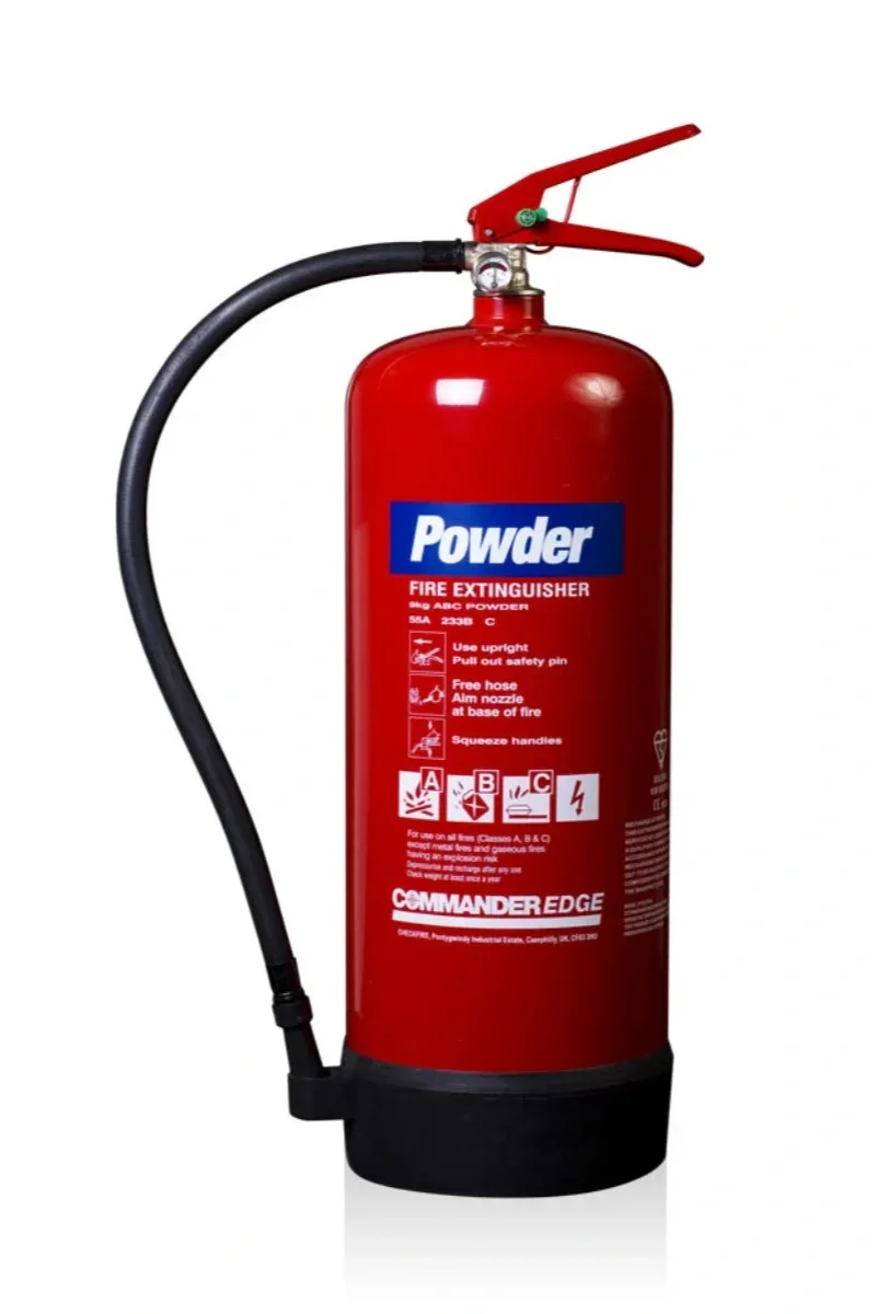 Red fire extinguisher labeled Powder, with instructions and safety symbols on the front.