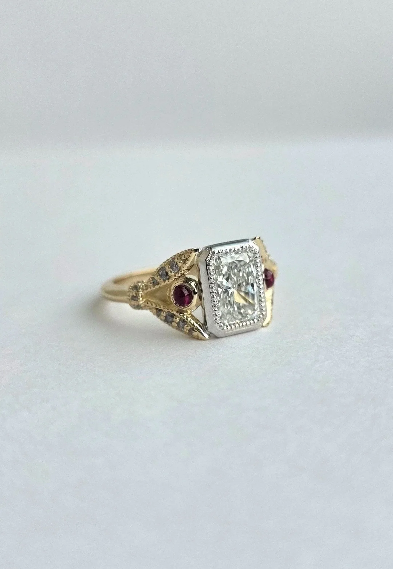 Custom vintage inspired ring  with radiant cut diamond centre and client's provided heirloom rubies and diamonds