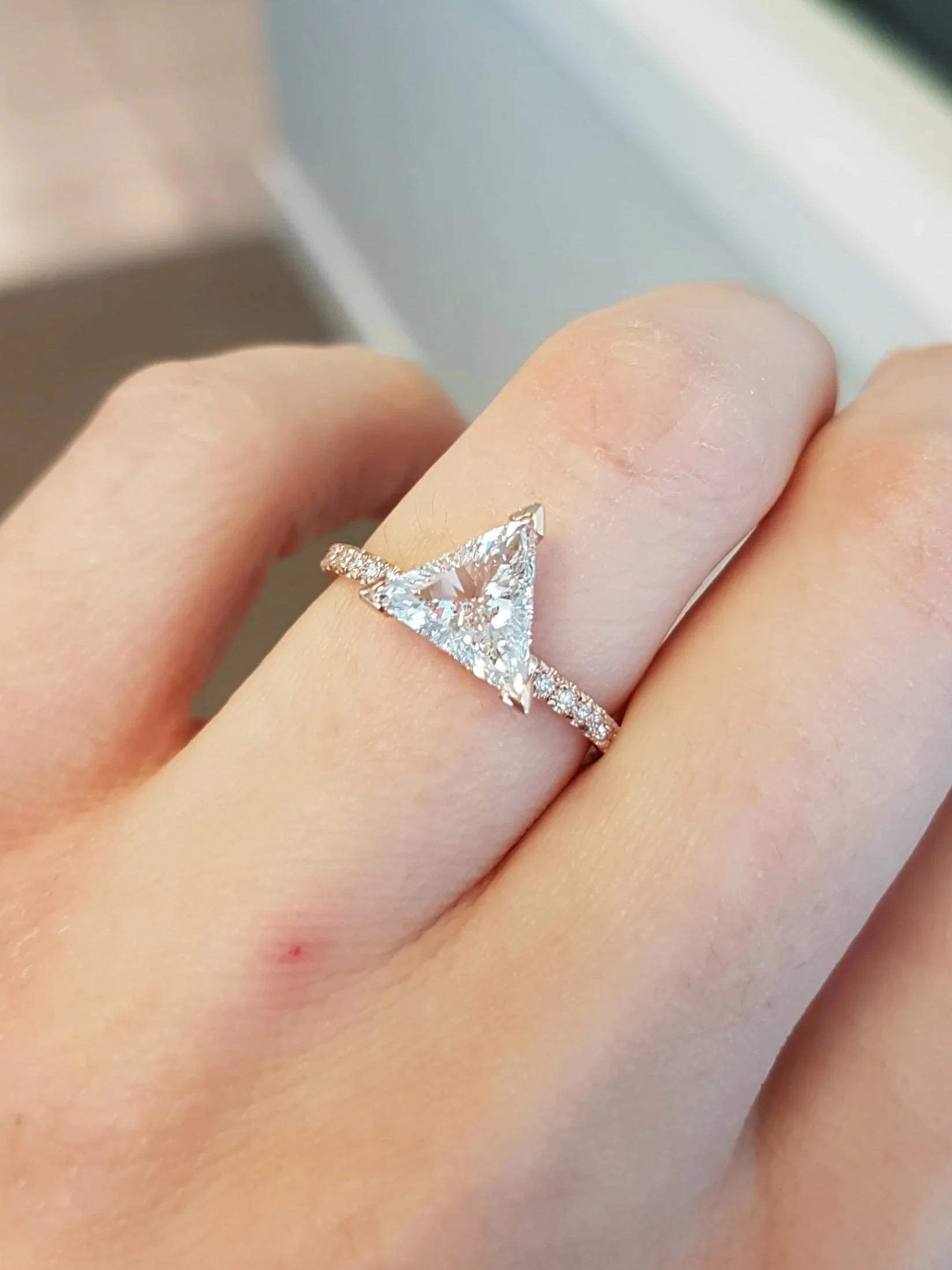 Trillon cut diamond engagement ring set in rose gold