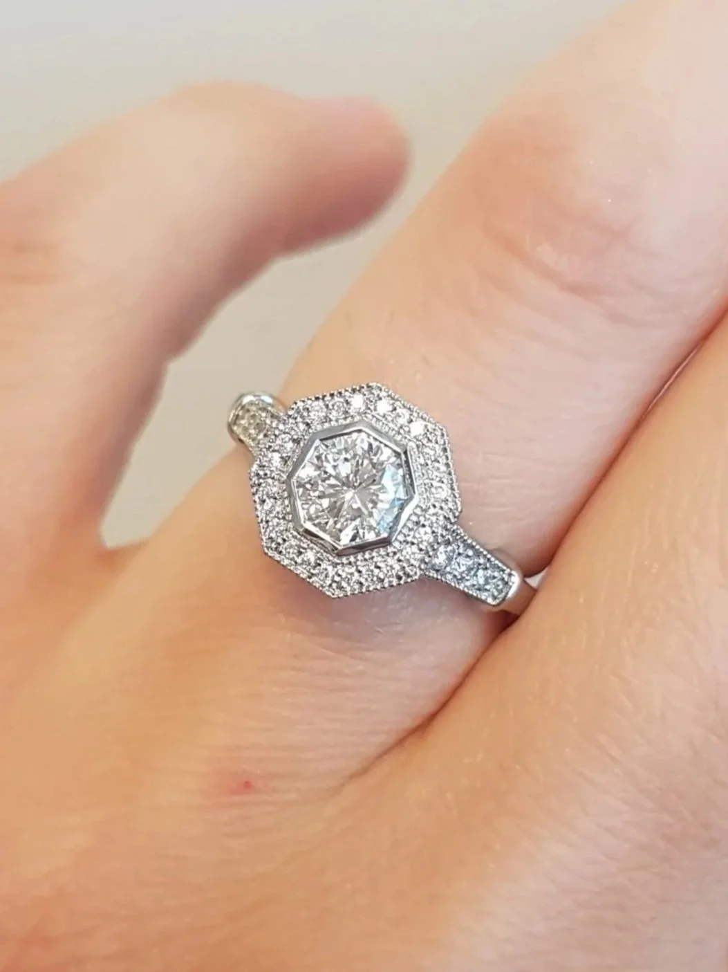 Octagon cut diamond set in halo pave engagement ring, 19K white gold