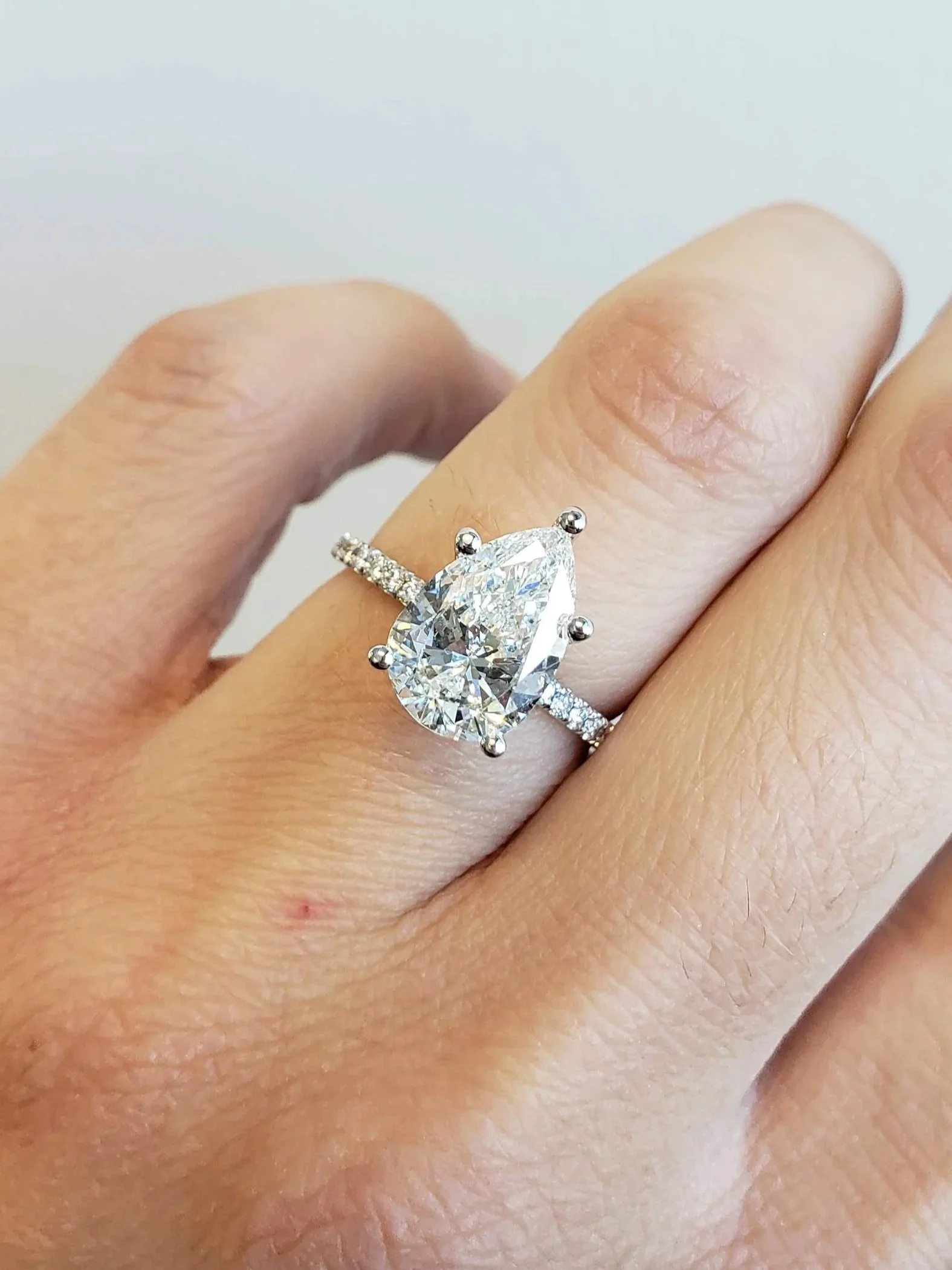 Pear shaped diamond engagment ring with micro pave diamond band