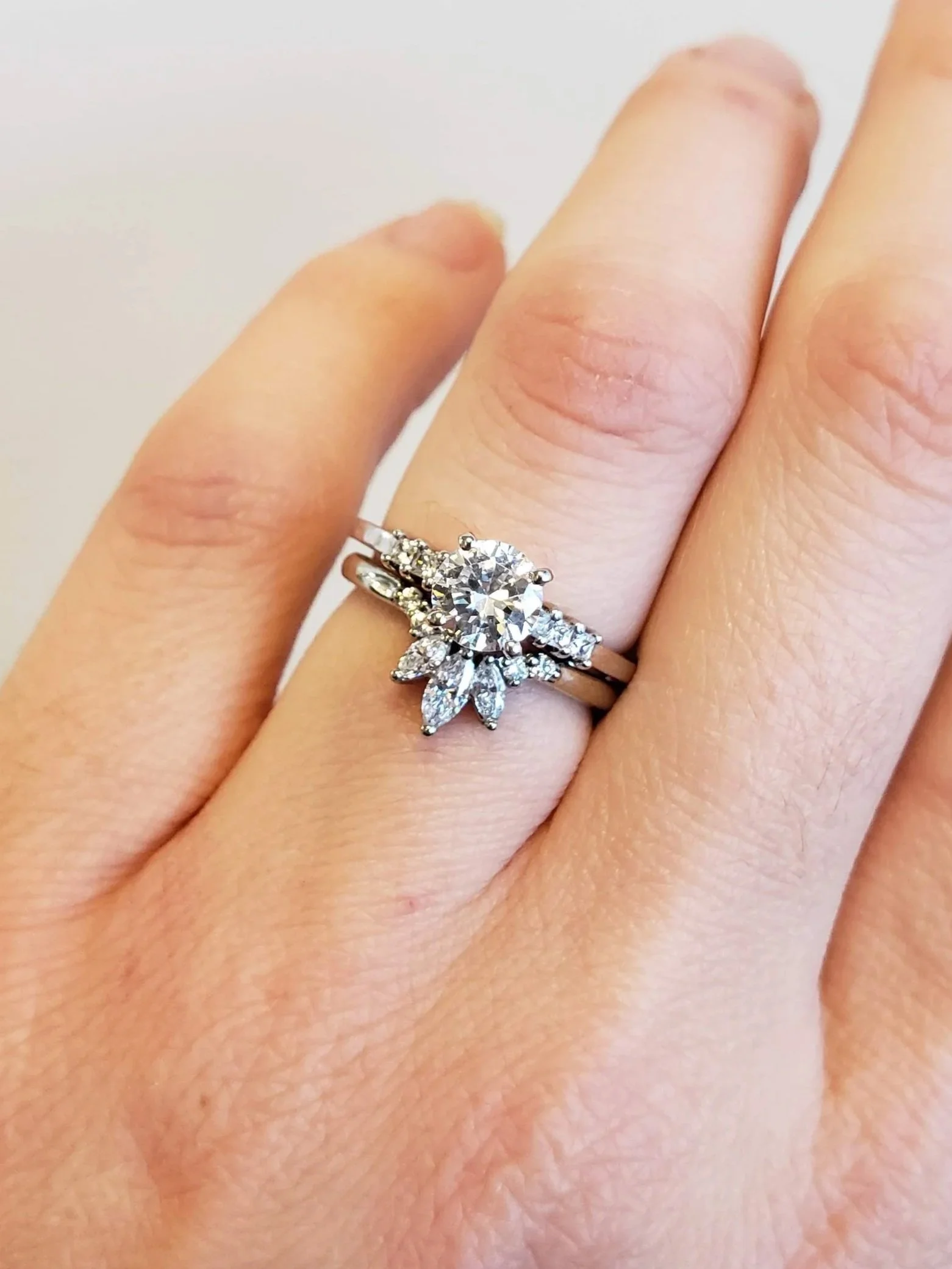 Round brilliant cut engagement ring with custom made wedding band with marquise cut diamonds