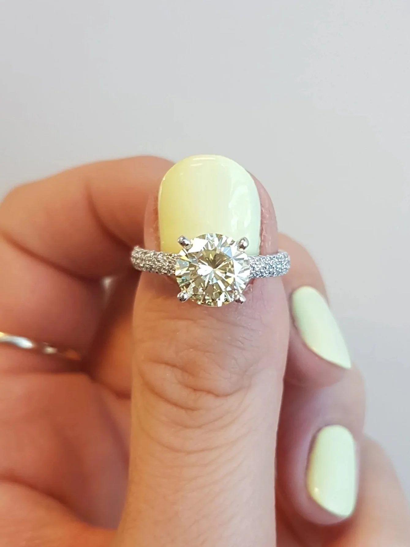 Light yellow diamond engagement ring set in white gold micro pave set diamond band