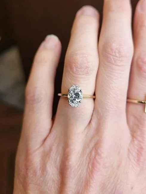 Round brilliant cut heirloom diamond engagement ring with illiusion halo to create oval shape