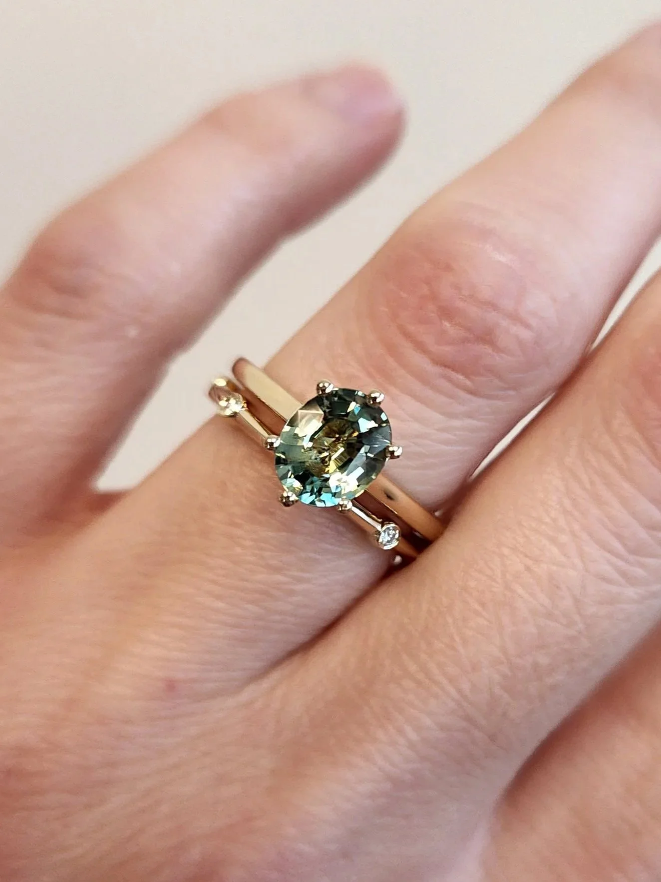 Green oval Montana sapphire engagement ring with matching diamond "galaxy" wedding band