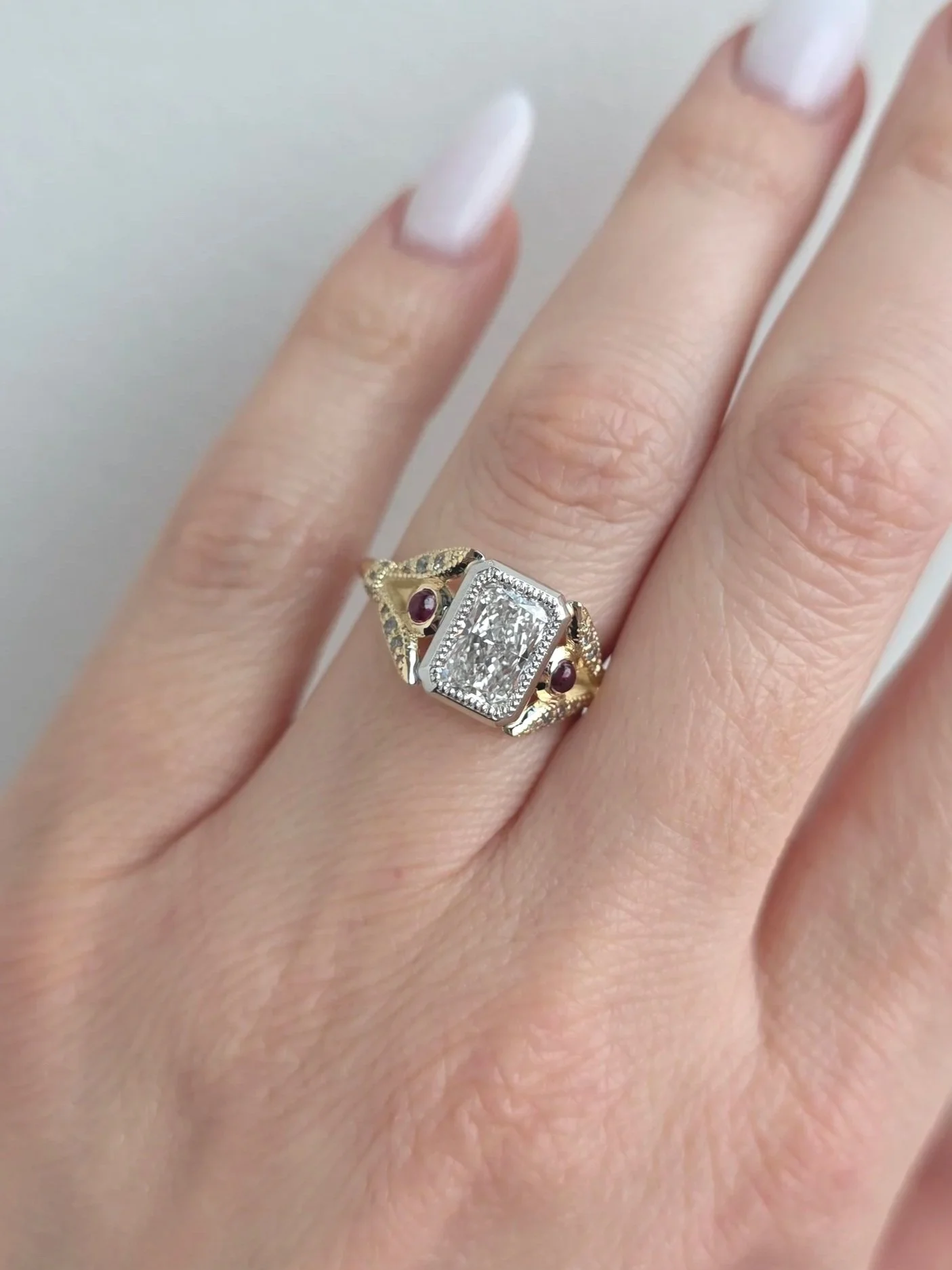 Custom vintage inspired ring  with radiant cut diamond centre and client's provided heirloom rubies and diamonds
[engagement]
[redesign]
