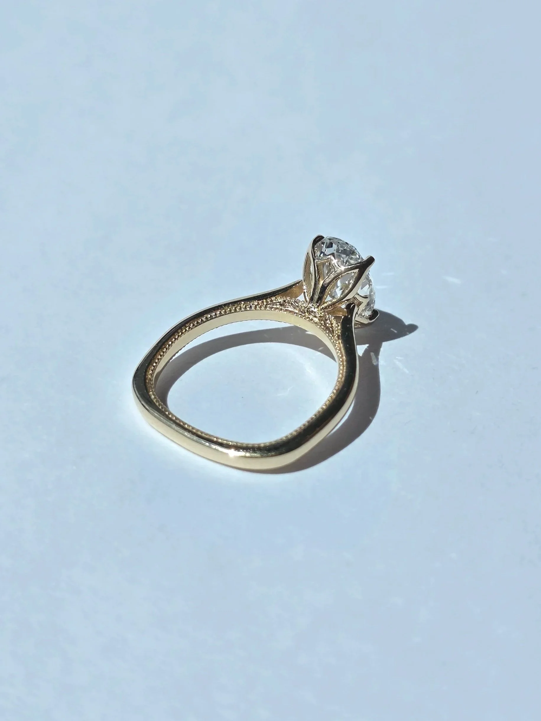 Oval diamond engagement ring with petal head, euro shank, and milgrain details

[engagement]