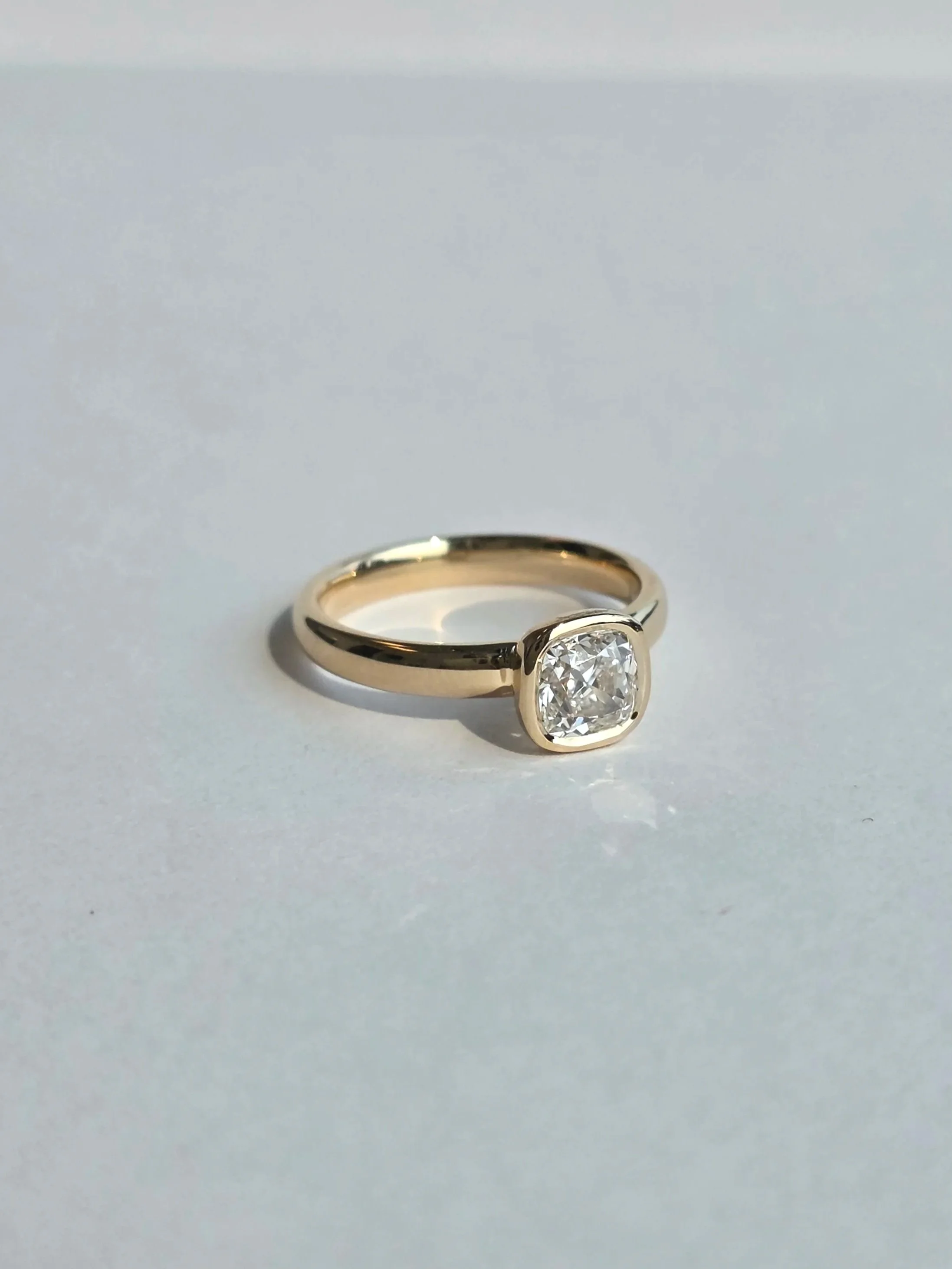 Cushion cut diamond bezel set solitaire yellow gold engagement ring
[engagement]
[redesign]