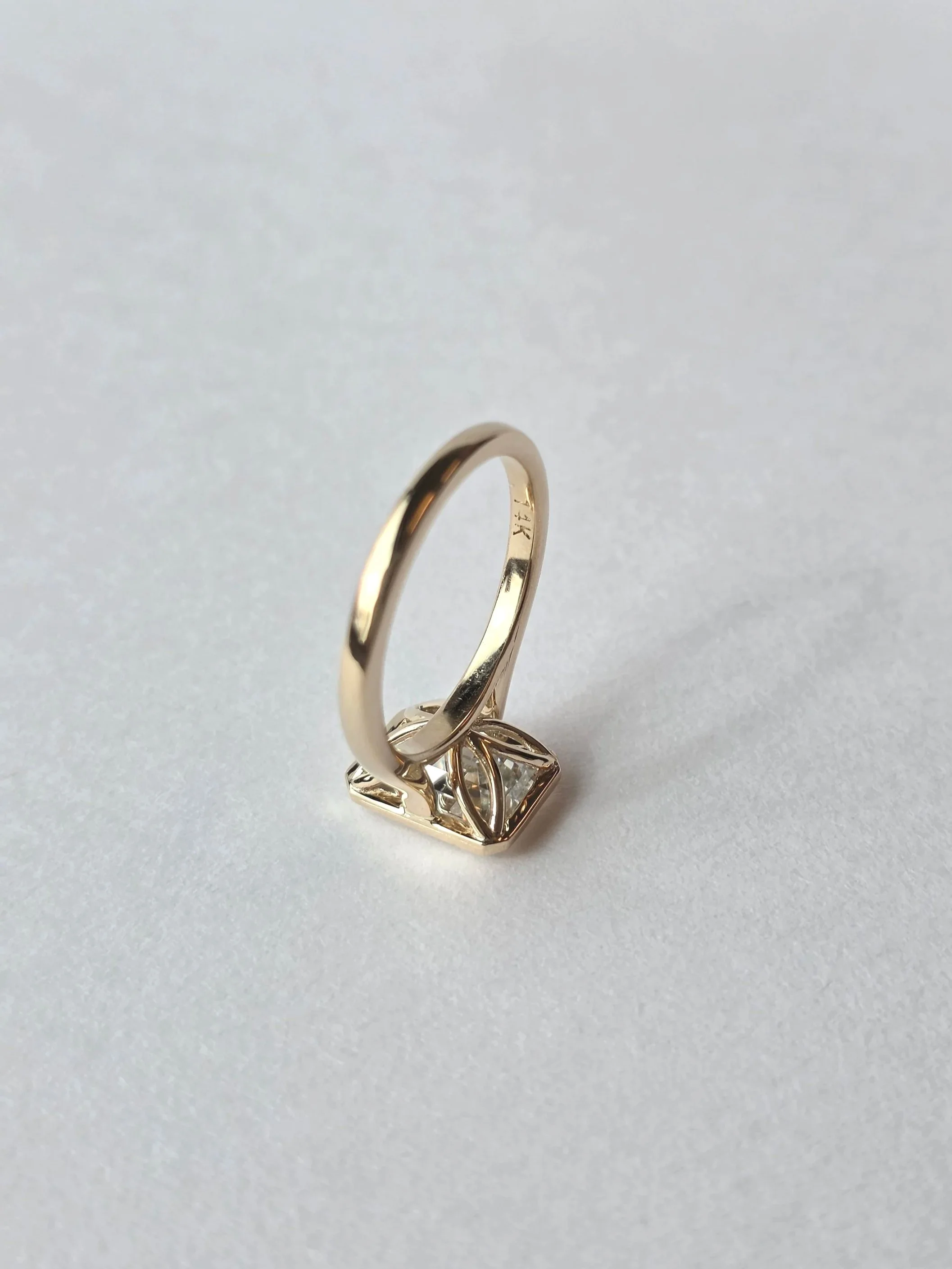Emerald cut bezel set with petal gallery
[engagement rings]