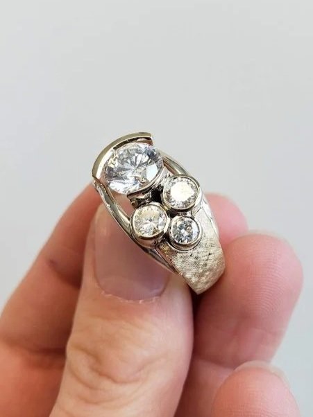 Custom redesign of client's existing diamonds into yellow and white gold ring with texture
[redesign]