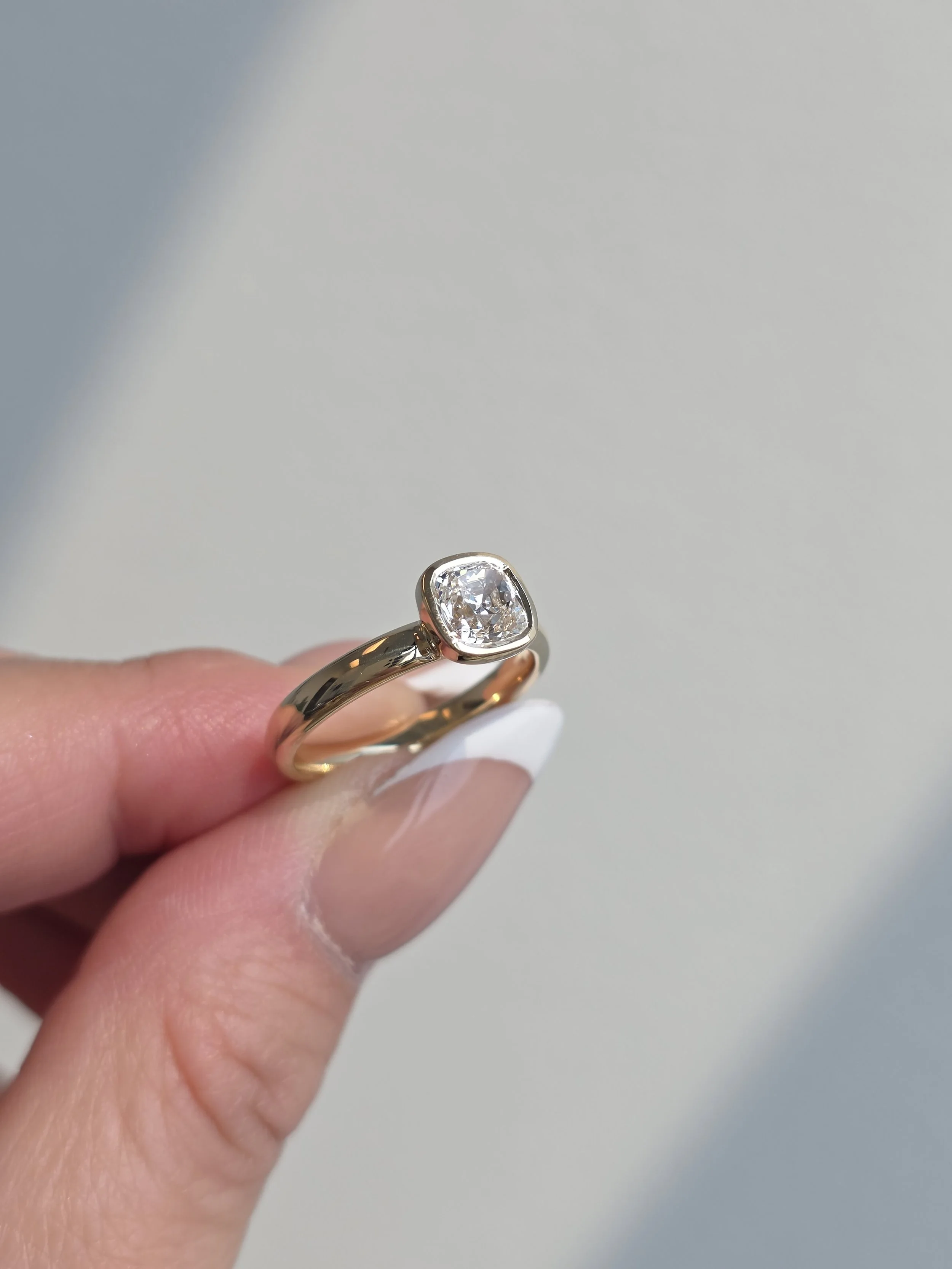 Cushion cut diamond bezel set solitaire yellow gold engagement ring
[engagement]
[redesign]