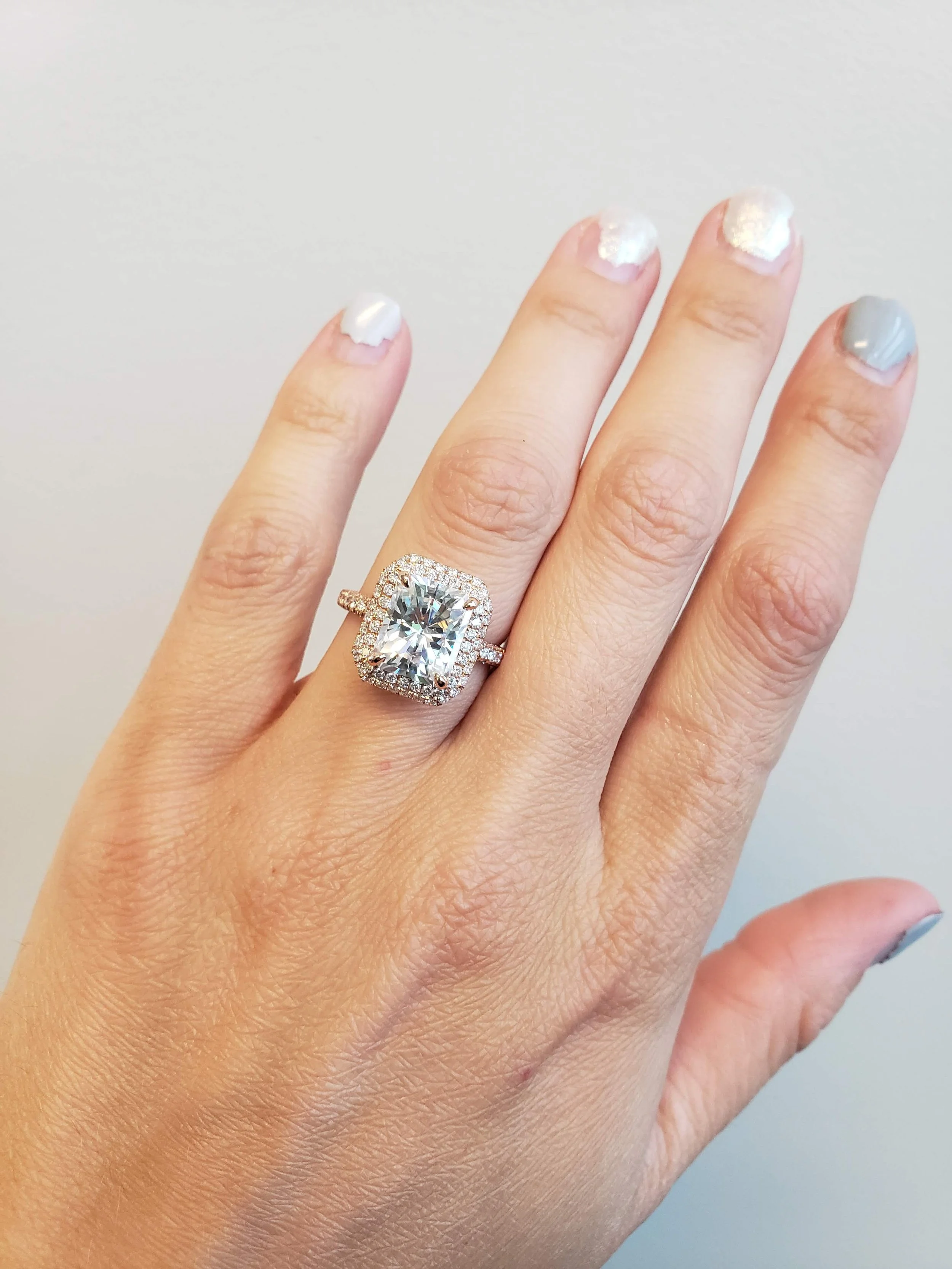 14K rose gold engagement ring with pave set accent settings and moissanite centre