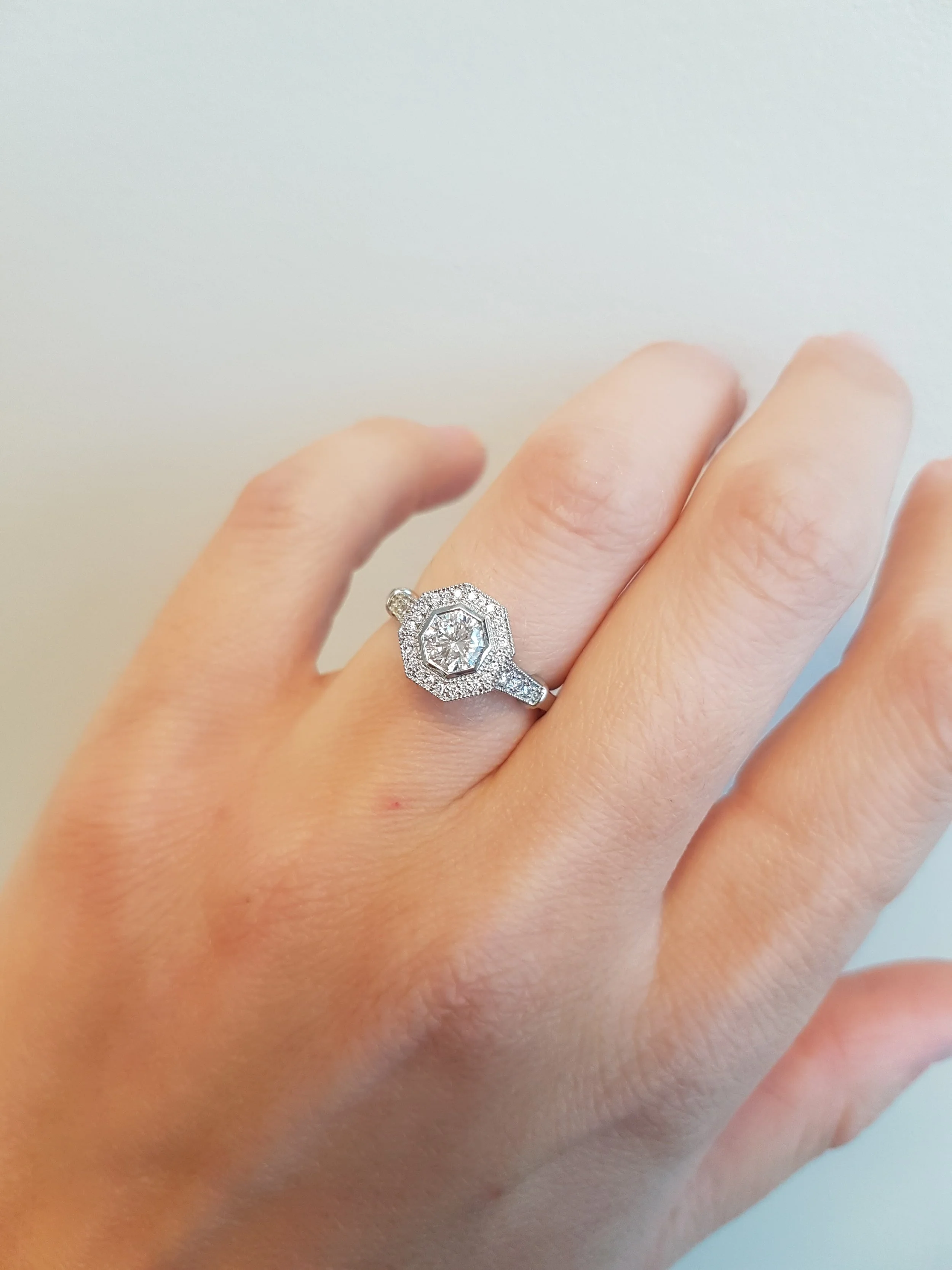 Octogon cut diamond set in halo pave engagement ring, 19K white gold