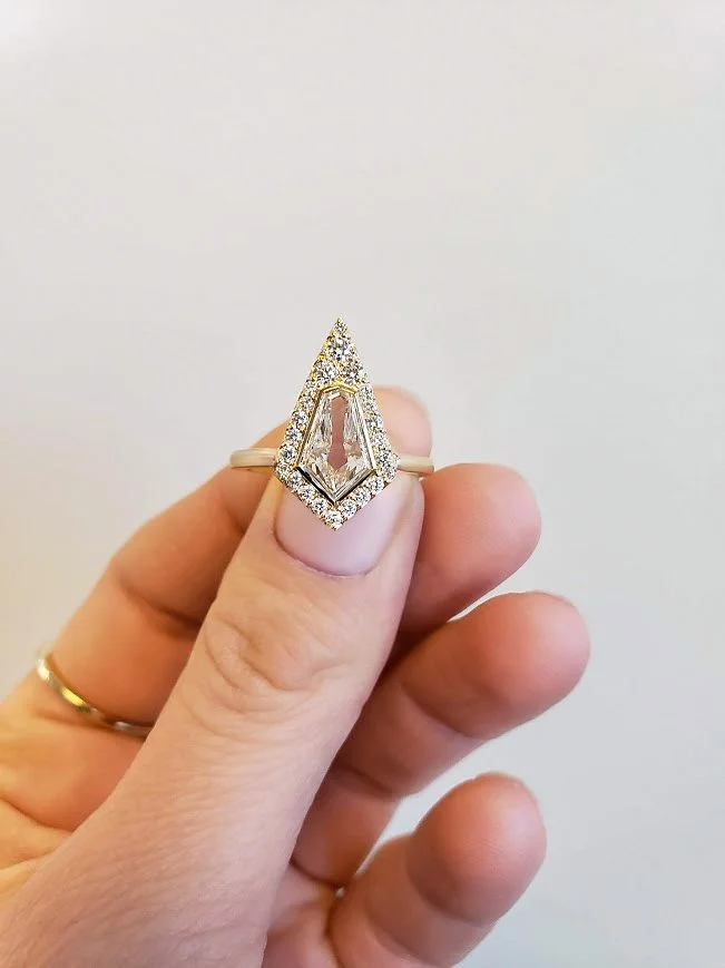 Kite or shield shaped diamond halo engagement ring