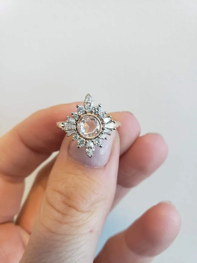 Custom engagement ring with milgrain bezel set rose cut centre, accented with marquise and round brilliant cut diamonds, 14K rose gold.