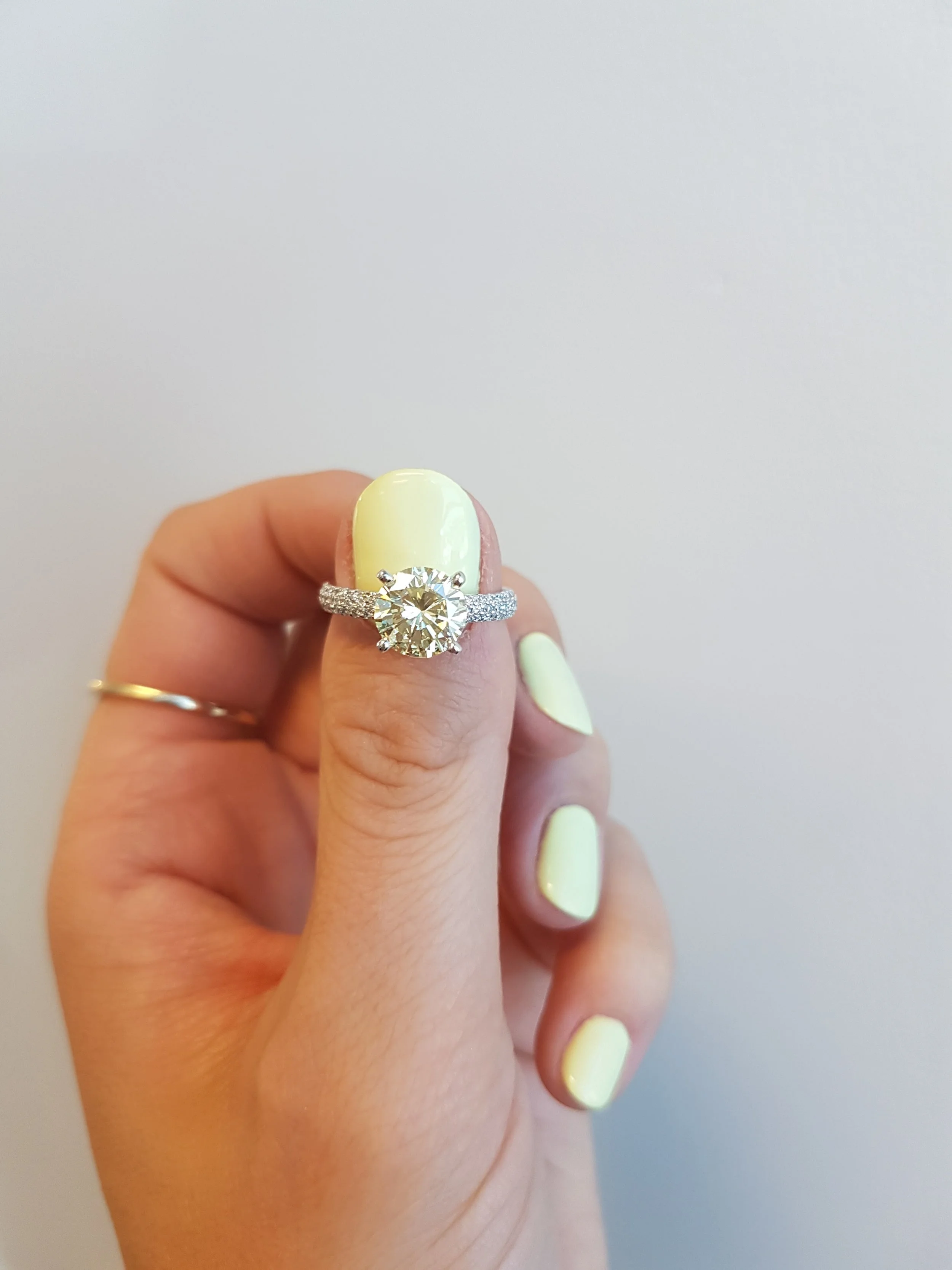 Light yellow diamond engagement ring set in white gold micro pave set diamond band
