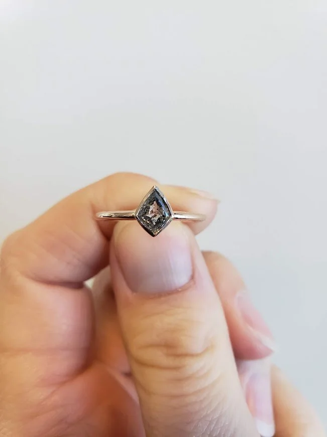 Kite shaped salt and pepper diamond bezel set engagement ring